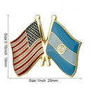 A lapel pin featuring the friendship flag of the USA and El Salvador, with a butterfly button closure.